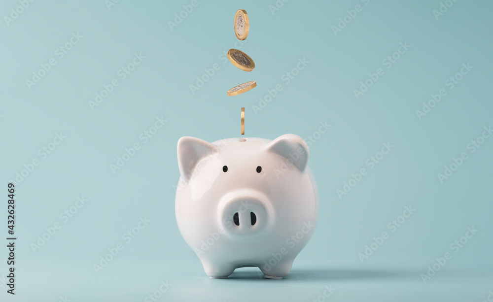 Coins falling to white piggy saving ,  Financial and money deposit concept.